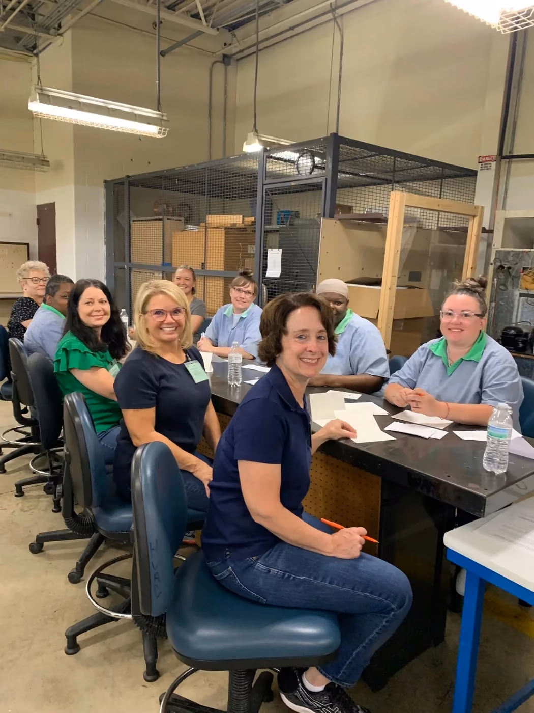 Four-Seven volunteers and participants gathered in a classroom.